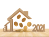 Investir dans l’immobilier à Montpellier en 2021 – Maisons en bois avec des pièces de monnaie qui tombent et les chiffres 2021 en bois.