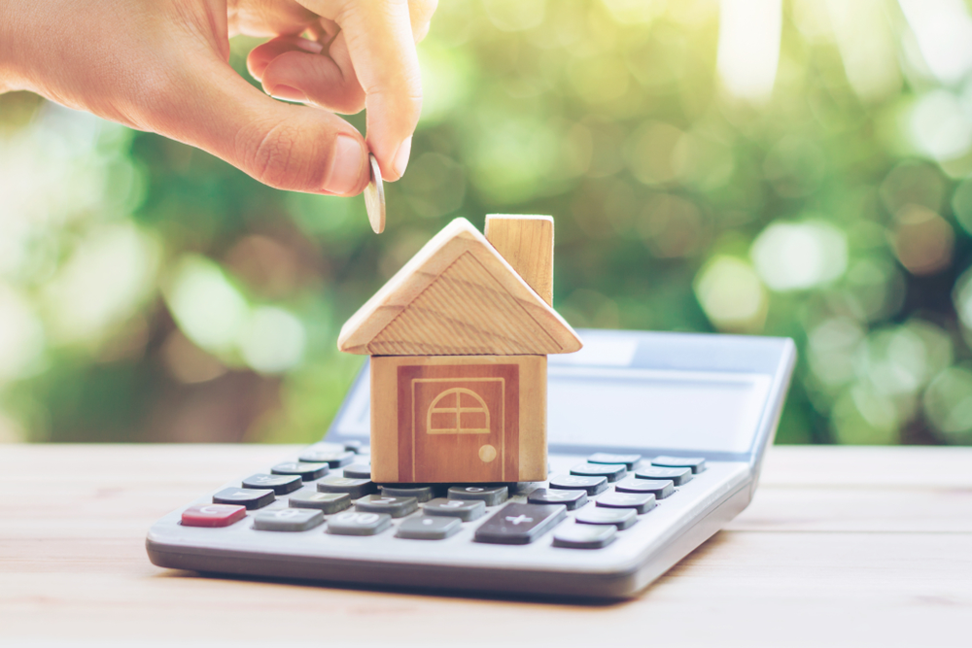 Maison en bois posée sur une calculatrice